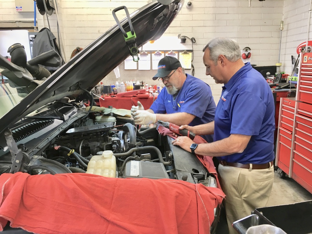 Rob and Steve working on a car at Jeno's Auto Service